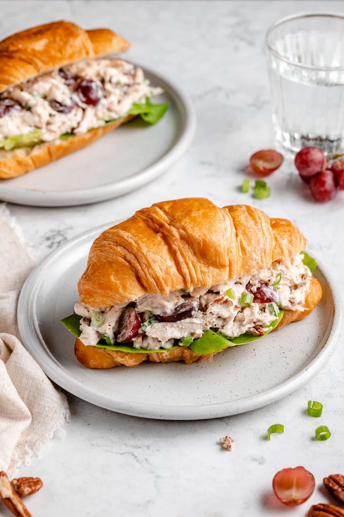 Chicken salad with grapes served on a croissant.