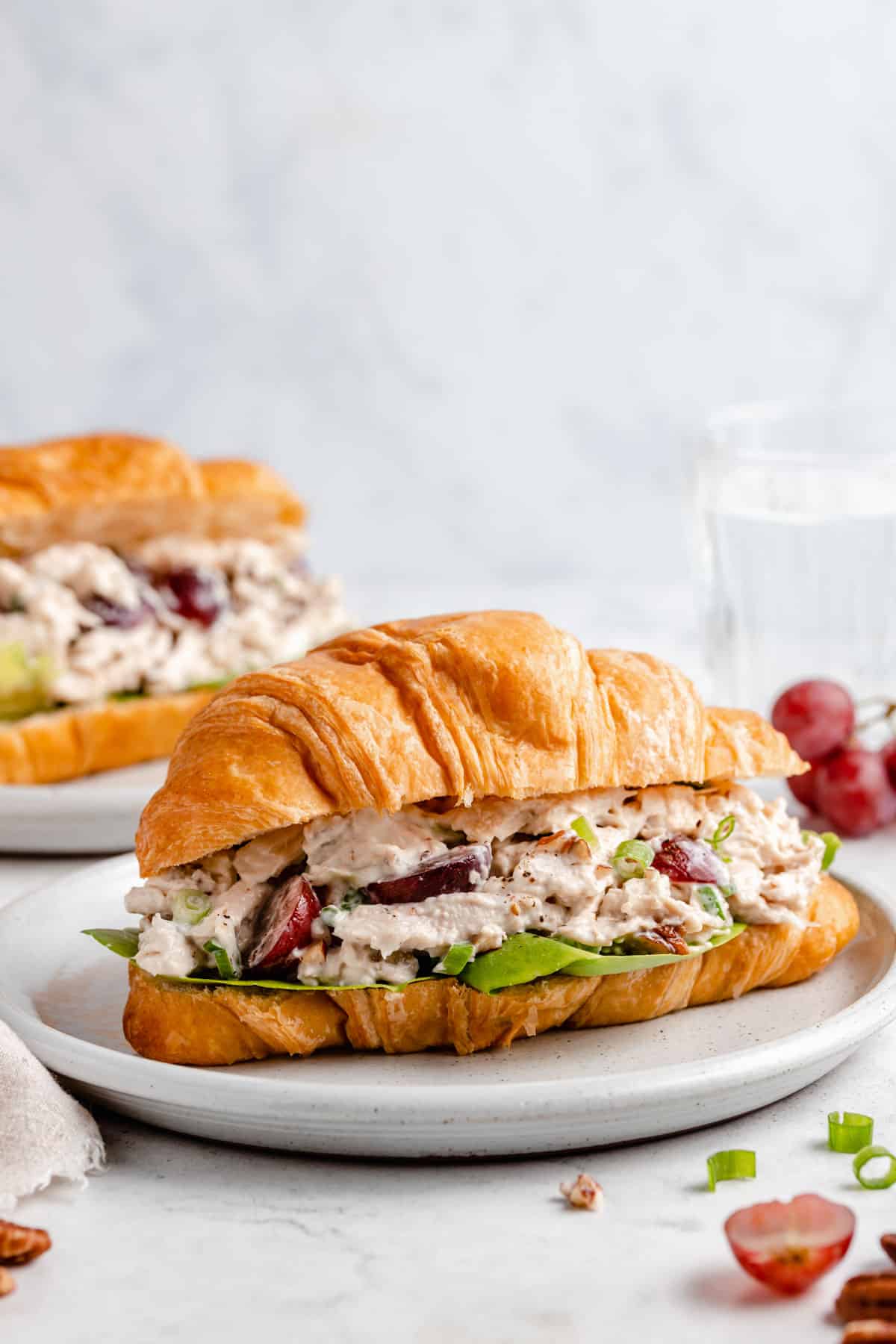 chicken salad sandwich with grapes and rotisserie chicken on a croissant 
