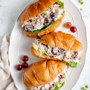 three chicken salad sandwiches made with croissants