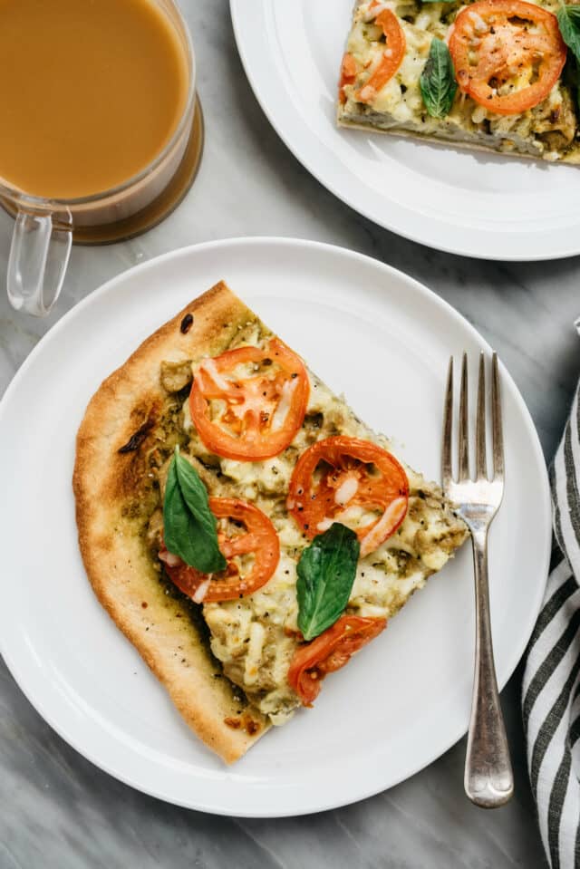 Breakfast Pizza served on white plate with coffee
