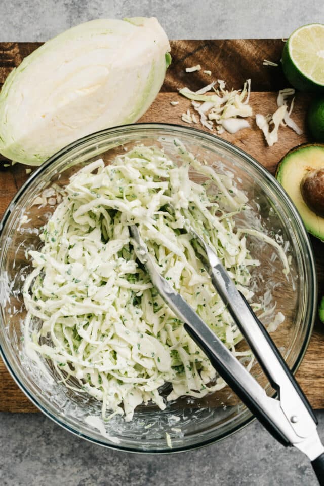 green cabbage slaw mixed in glass bowl