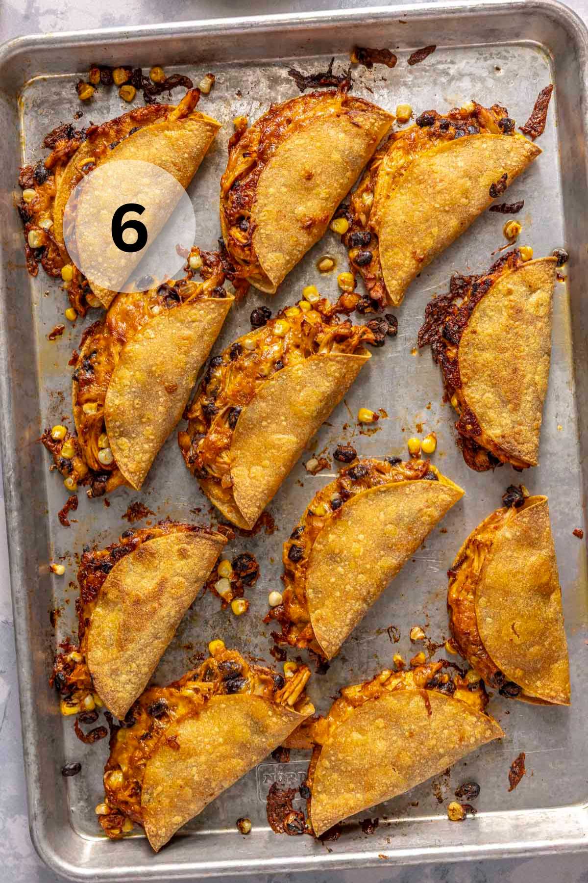 Crispy chicken tacos on a sheet pan.
