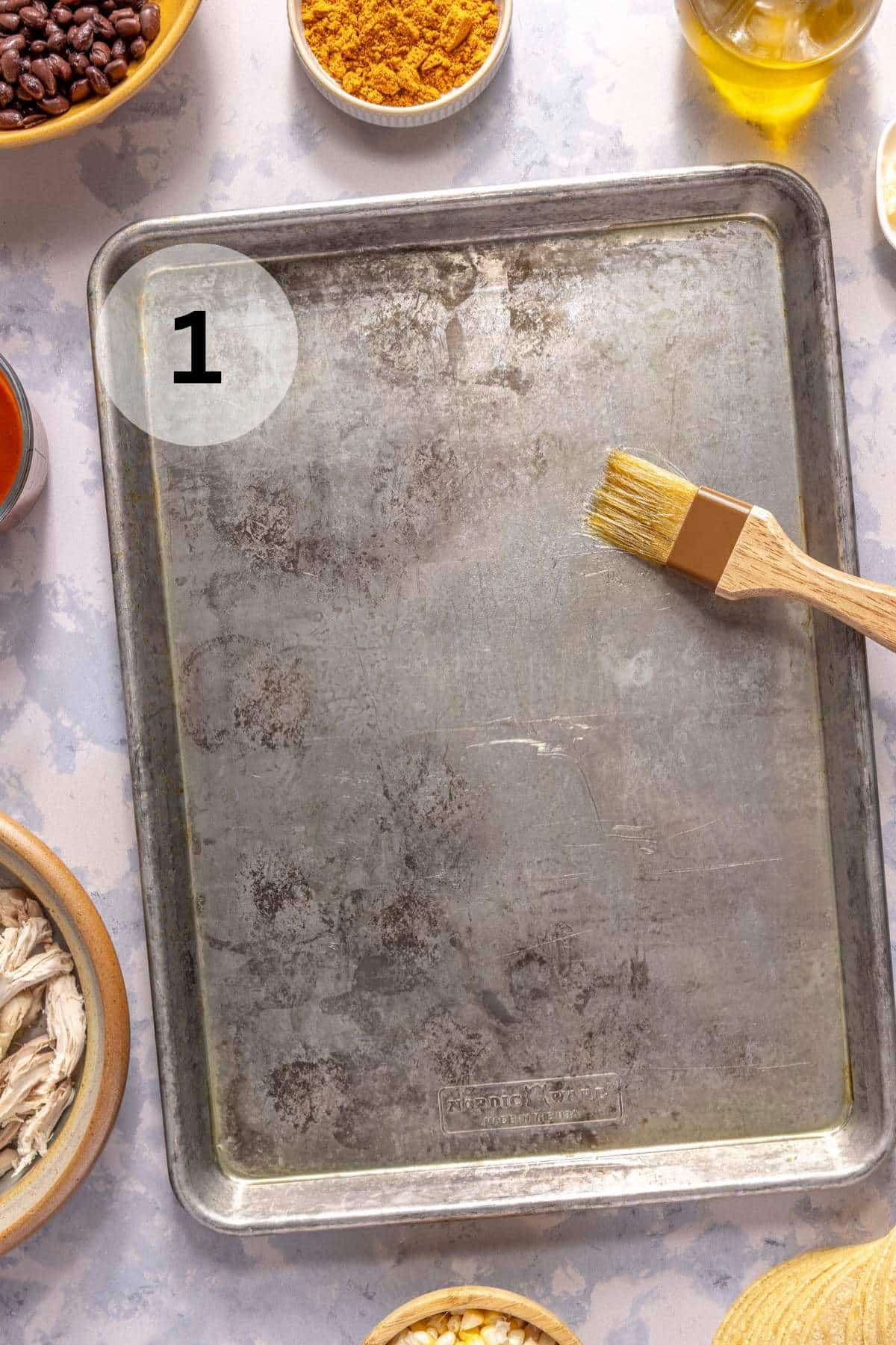 Greasing a sheet pan with a pastry brush.