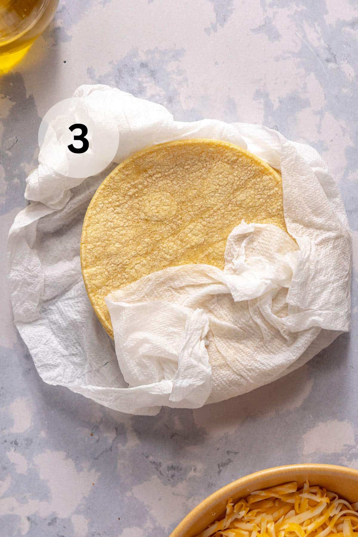 Corn tortillas in a damp paper towel.