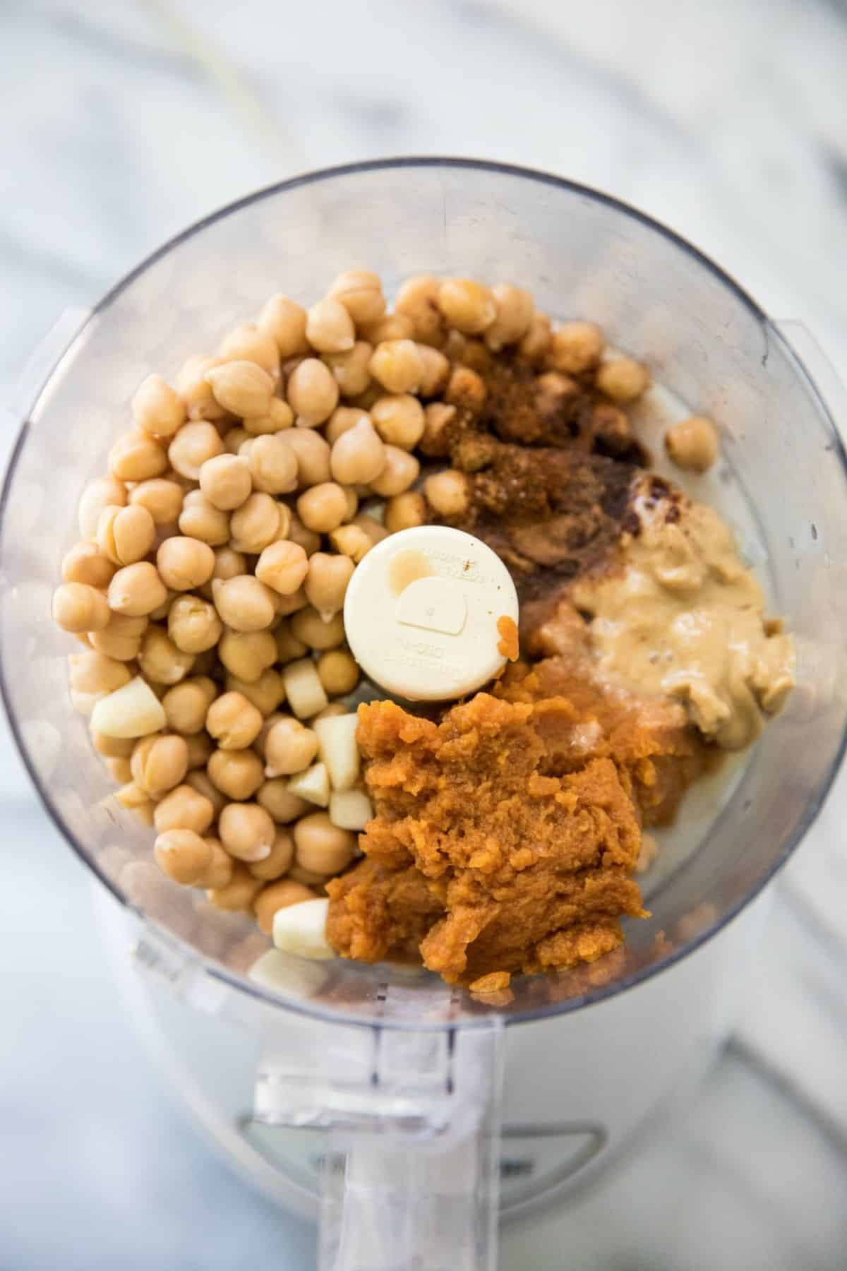 Chickpeas, pumpkin, spices and tahini in a food processor.