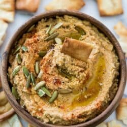 Pumpkin hummus topped with pumpkin seeds, paprika and olive oil.