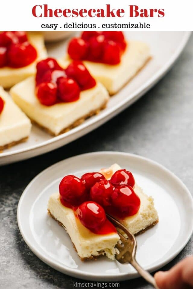 cheesecake bars served on a white plate with a fork taking a bite