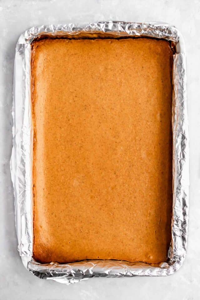 Baked pumpkin cheesecake in a 9x13-inch pan.