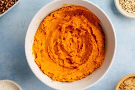 Mashed sweet potatoes in a white bowl.