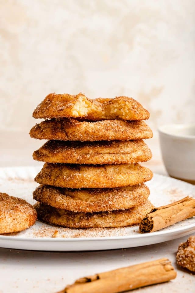 snickerdoodles stacked on a white plate