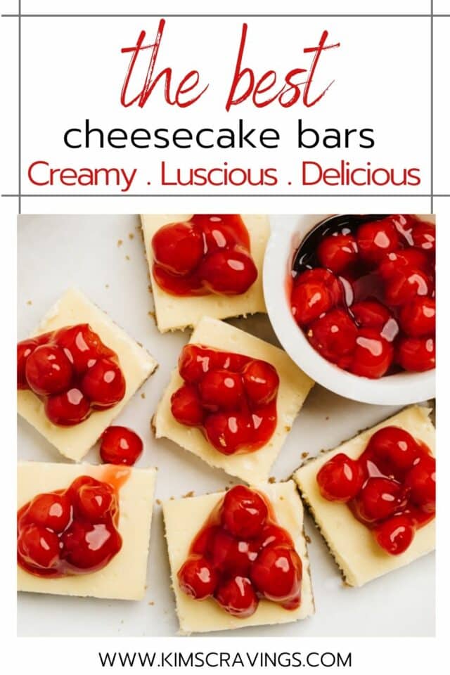 cheesecake bars topped with cherries on a white serving plate