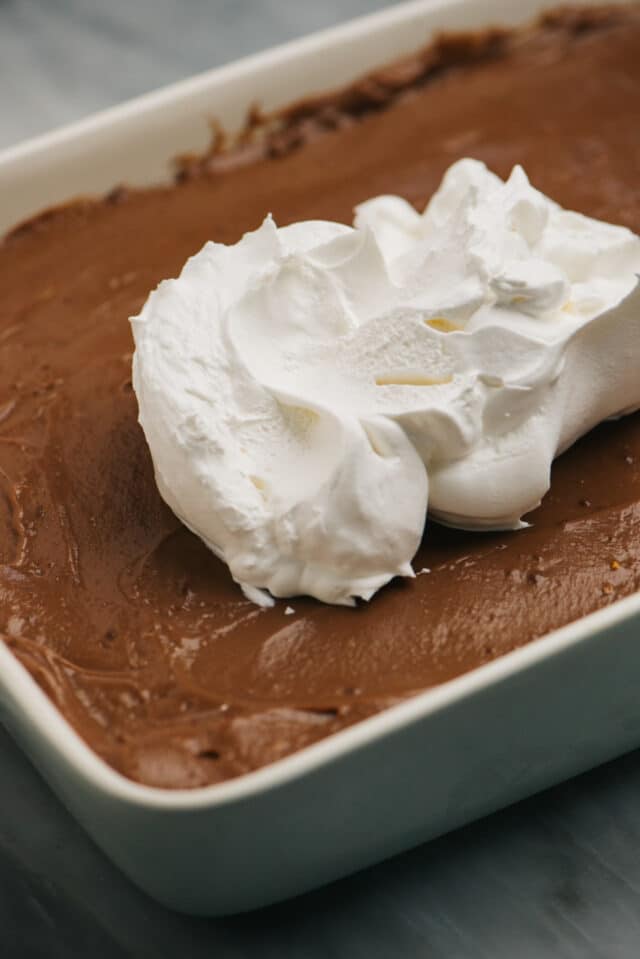 spread the Cool Whip layer on top of the chocolate pudding layer