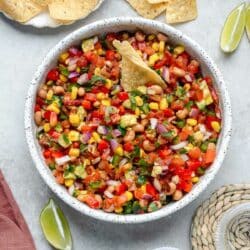 Cowboy caviar dip with a tortilla chip dipped in the middle.