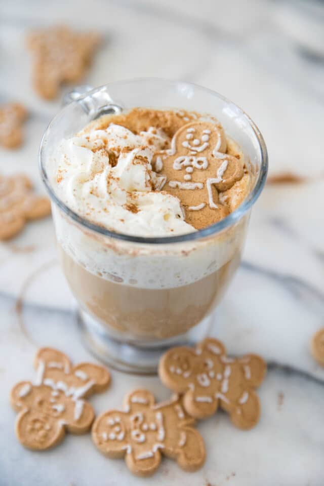 coffee with whipped cream and a gingerbread man cookie