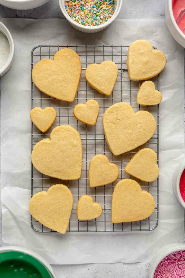 Heart-shaped sugar cookies on a wire rack.