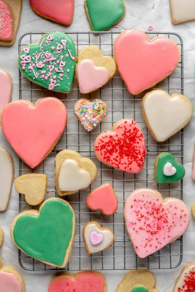 Decorated heart sugar cookies on a wire rack.