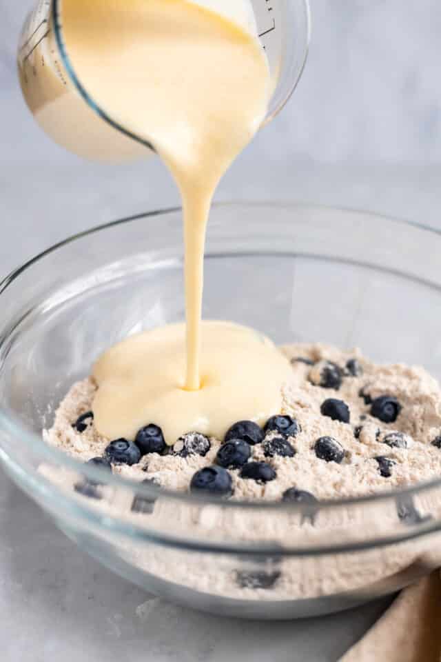 pour wet ingredients into dry ingredients to make Buttermilk Blueberry Muffins