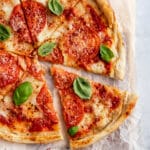 Margherita Pizza on parchment paper and sliced