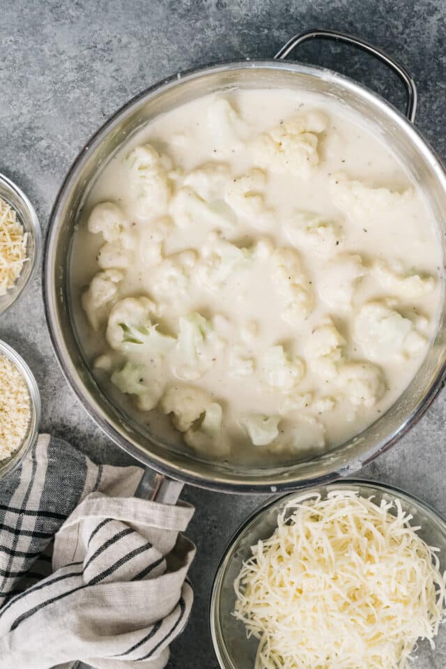 combine cauliflower in a large pot with cheese and milk 