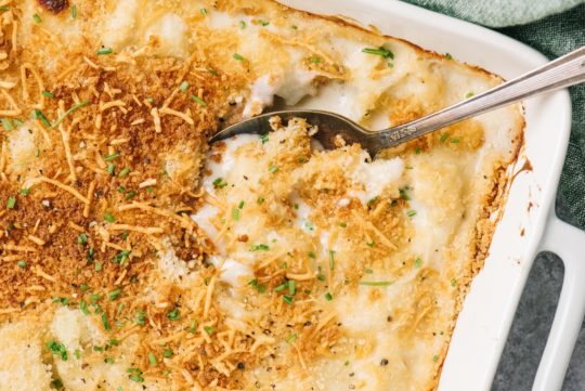 cauliflower au gratin being served with a large serving spoon