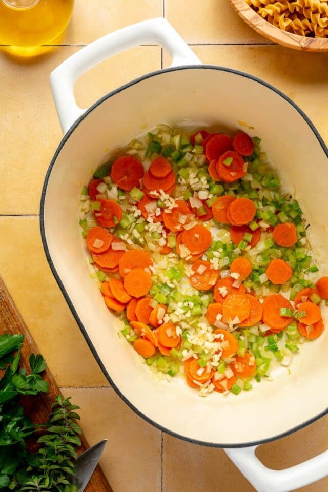 Carrots, onion, celery and garlic sautéing in a dutch oven.