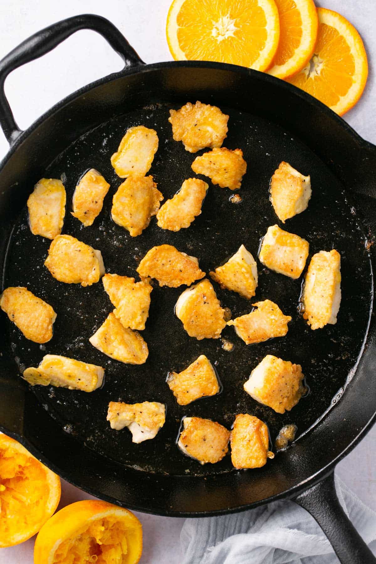 Cooking small pieces of chicken in a skillet.