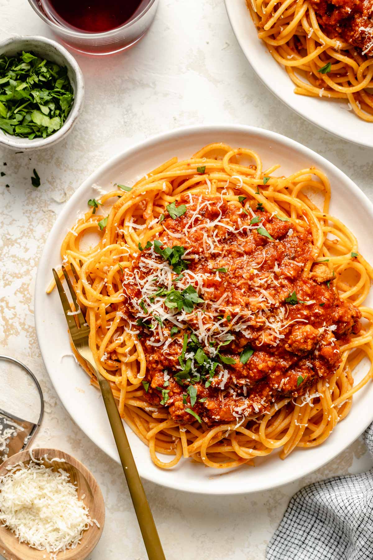 Italian sausage pasta on a white plate with a fork