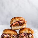 sliders filled with pulled pork and coleslaw