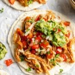 Shredded chicken with Pico de Gallo and guacamole on a flour tortilla.