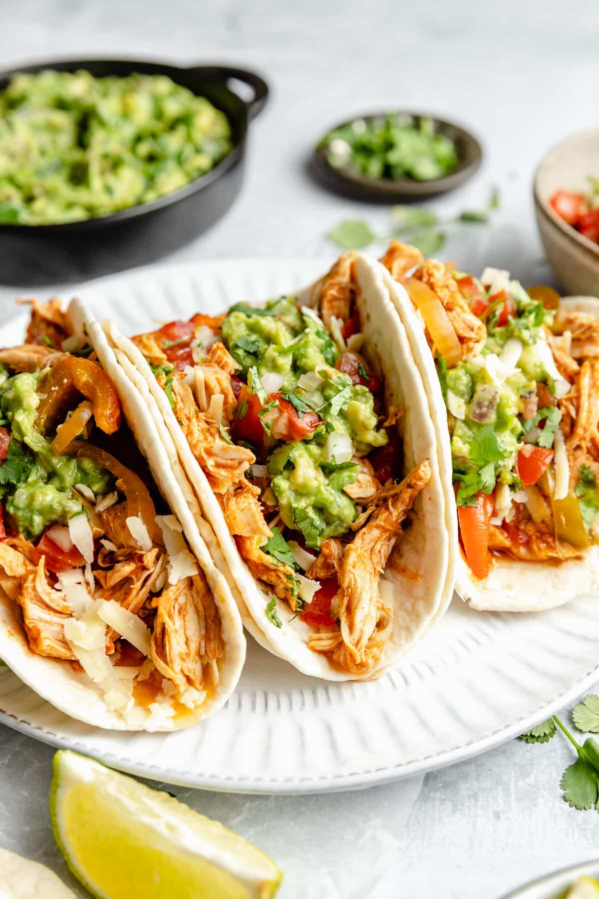 Chicken fajitas topped with tomatoes, onions and guacamole.
