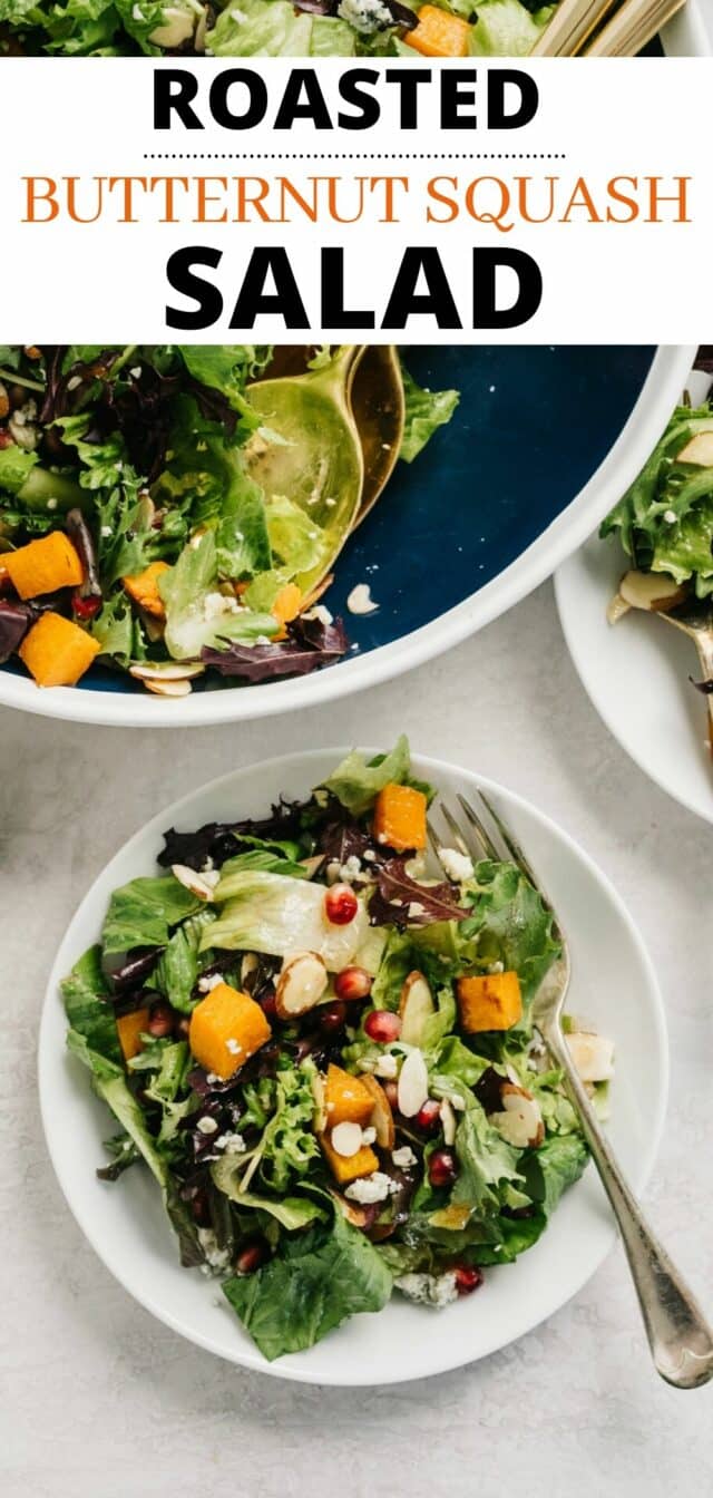 a salad topped with roasted butternut squash, gorgonzola cheese, almonds and pomegranate seeds