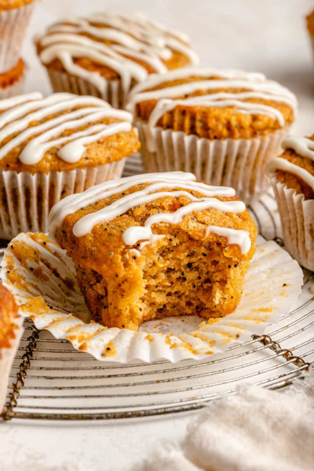 Carrot muffins drizzled with cream cheese frosting.