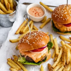 bacon cheese stuffed burgers dripping with burger sauce and served with French fries