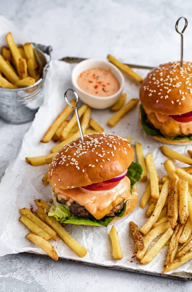 bacon cheese stuffed burgers served with French fries