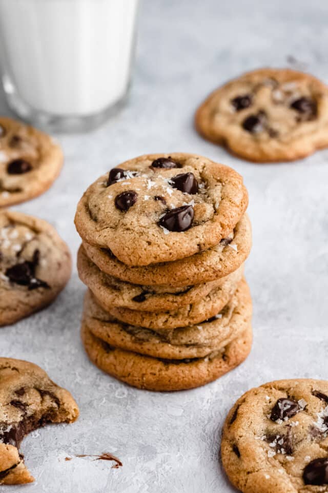 a stack of chocolate chip cookies served with milk