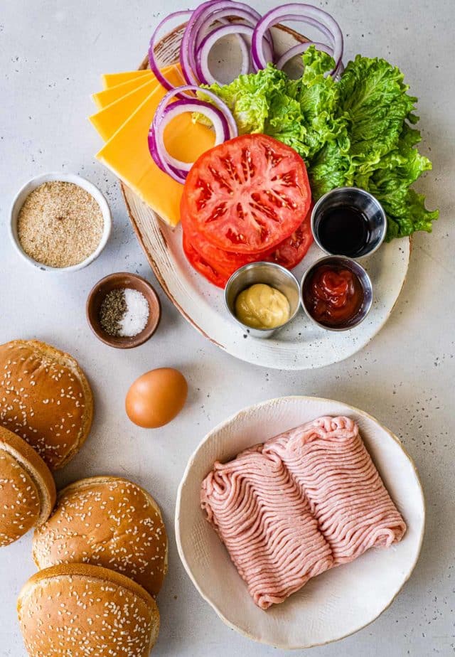 Burger ingredients on a white serving plate.