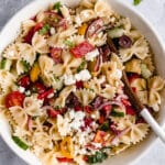 large white serving bowl filled with Greek pasta salad