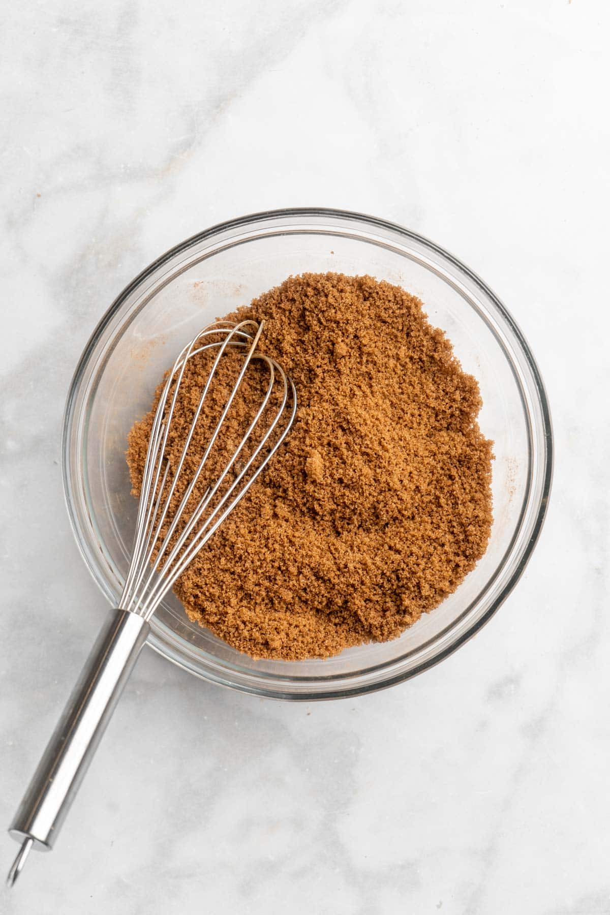 Cinnamon and sugar mixture in a small bowl with a whisk.