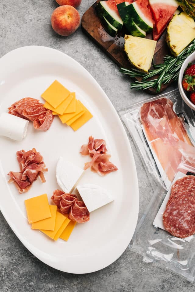 showing how to lay meat and cheese to a serving platter