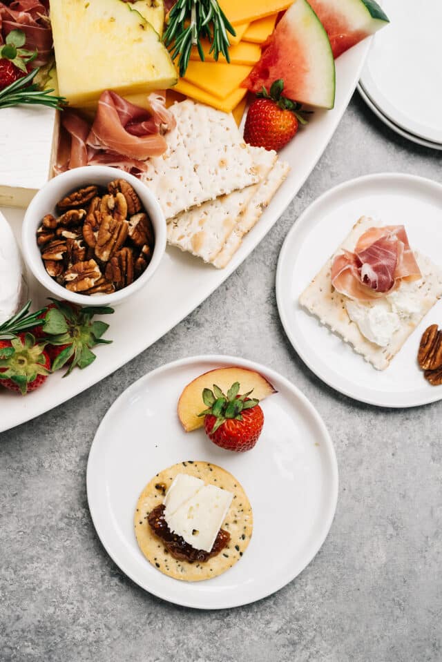 summer charcuterie board ideas showing a plate with crackers, jelly, cheese and fruit