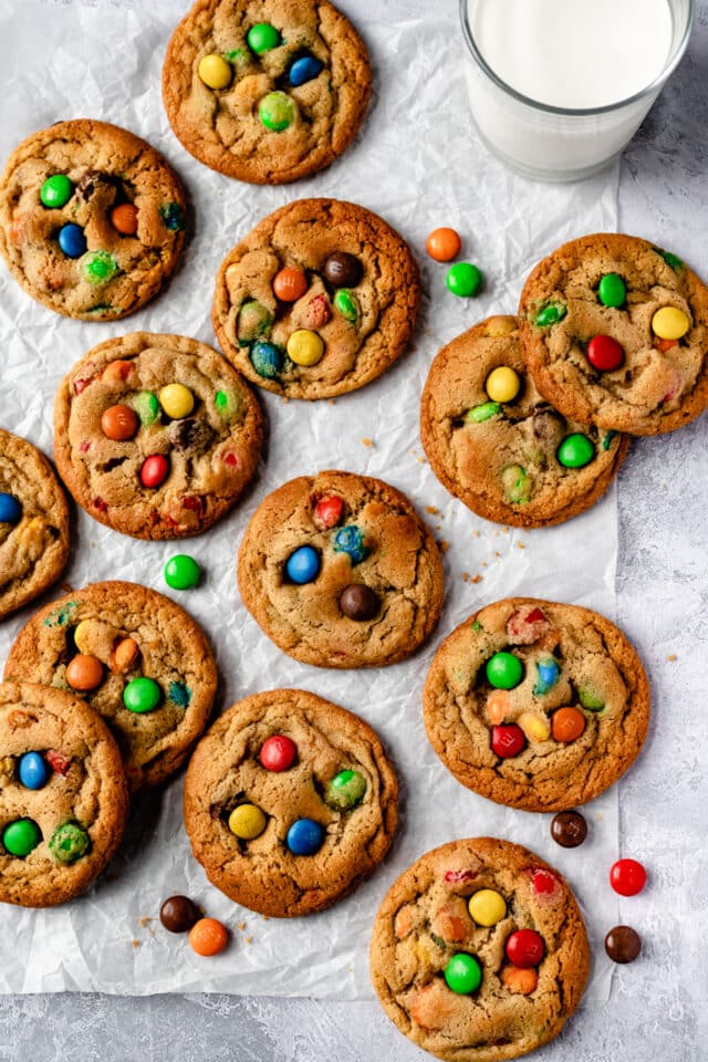 M&M Cookies spread out on parchment paper