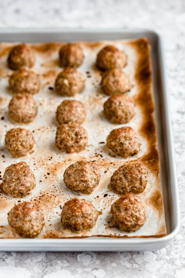 cooked turkey meatballs on a baking sheet pan 