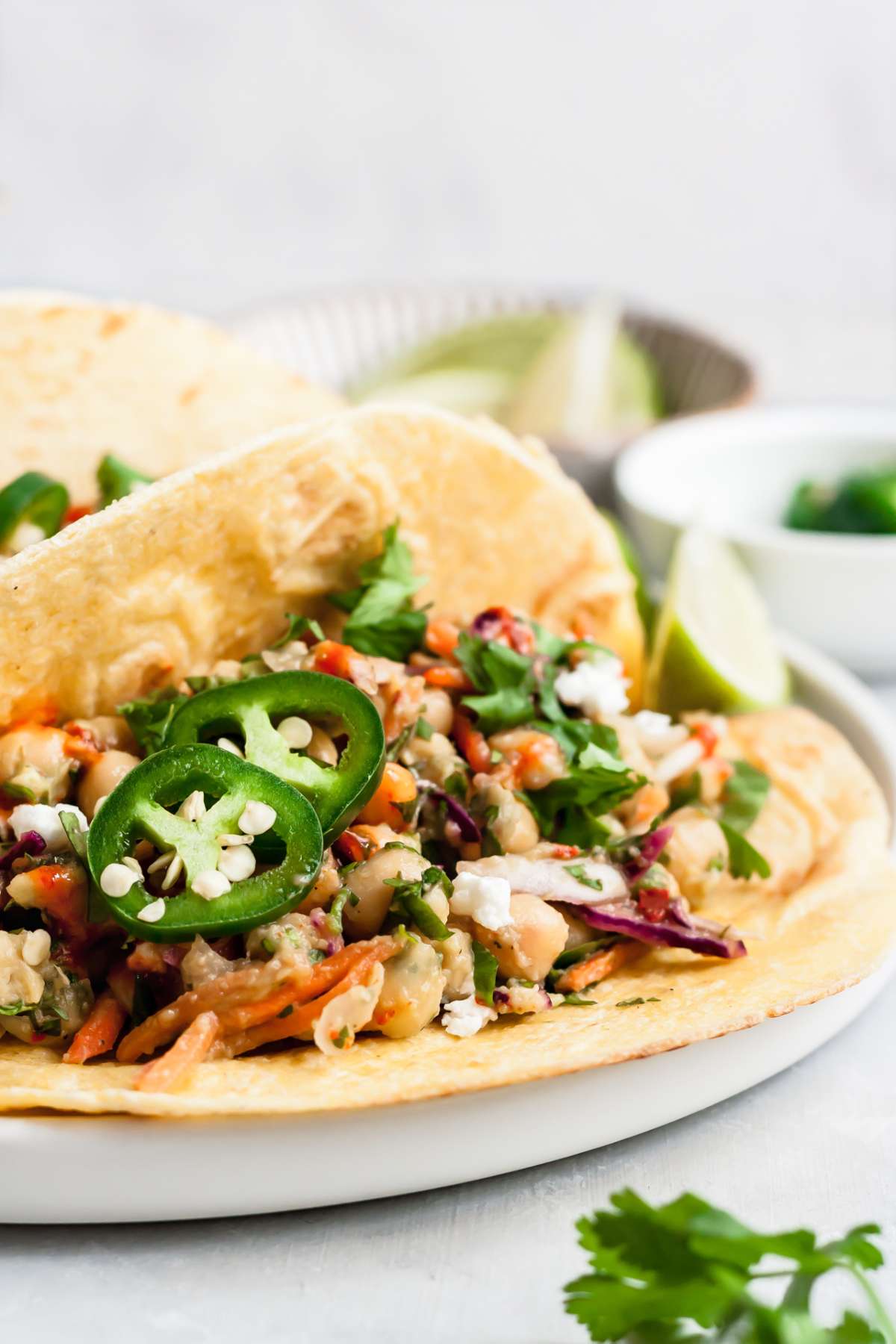 Vegan taco with a chickpea veggie filling and sliced jalapeños on top.