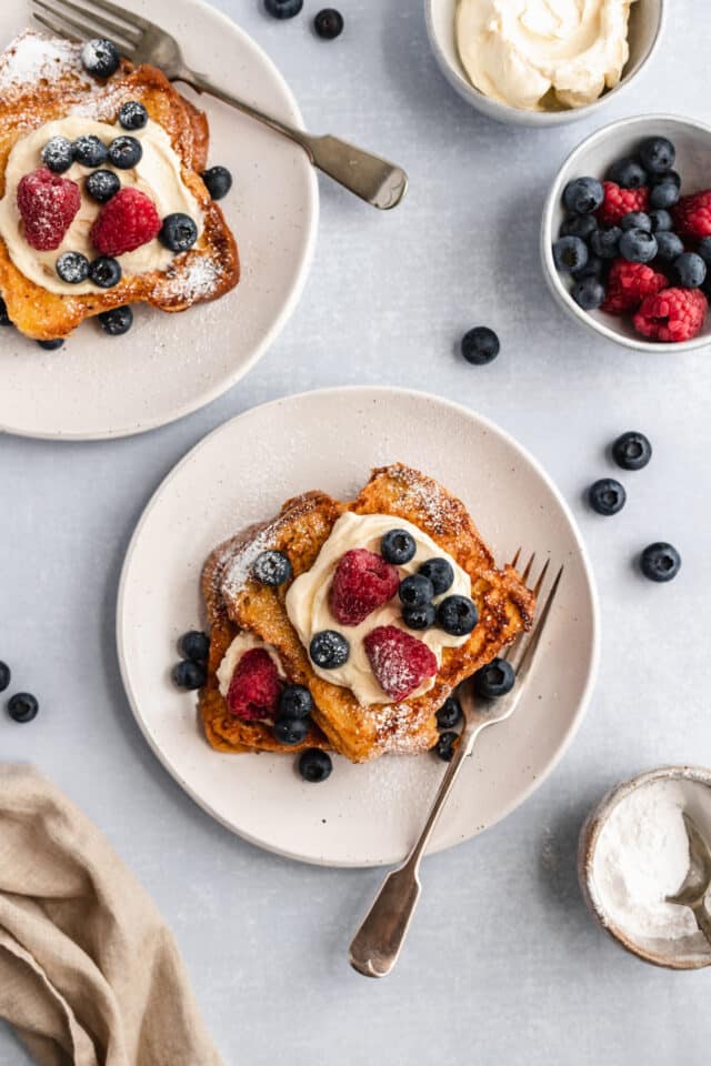 brioche French toast served with whipped topping and berries