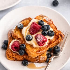 Brioche French toast topped with yogurt and berries.