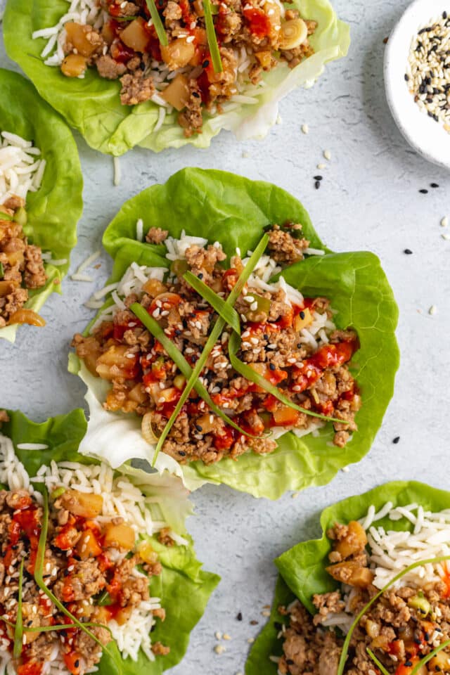 chicken lettuce wraps with rice and sriracha sauce 