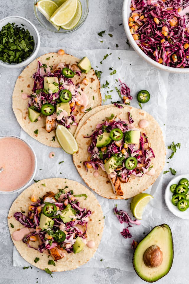 grilled chicken tacos with corn slaw, avocado and sliced jalapeño