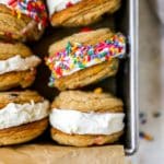 Ice cream cookie sandwiches stacked in a loaf pan.
