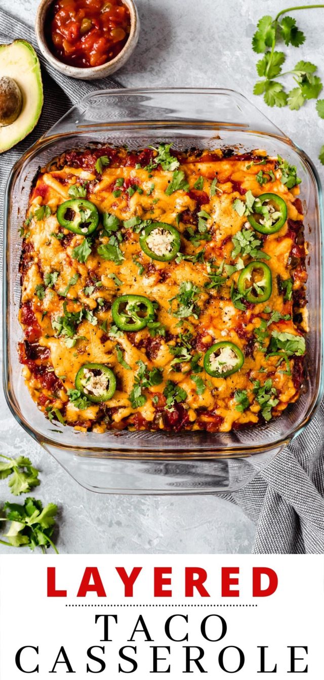 Layered Taco Casserole in a glass baking dish topped with sliced jalapeño and fresh cilantro