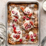 French toast casserole on large sheet pan topped with greek yogurt and fresh fruit
